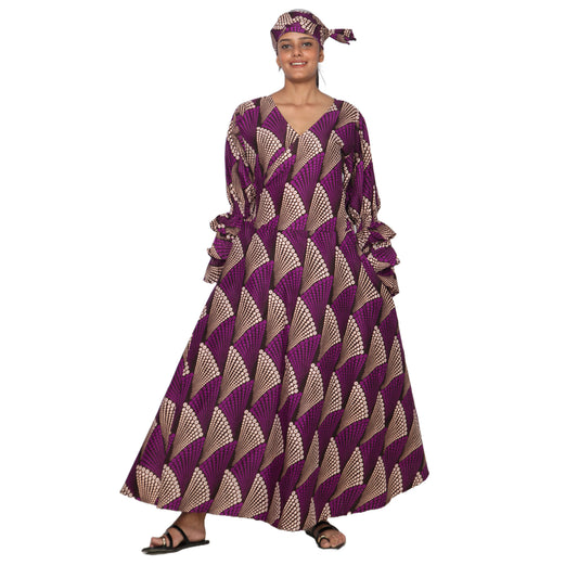Woman wearing a long, patterned dress with a white background