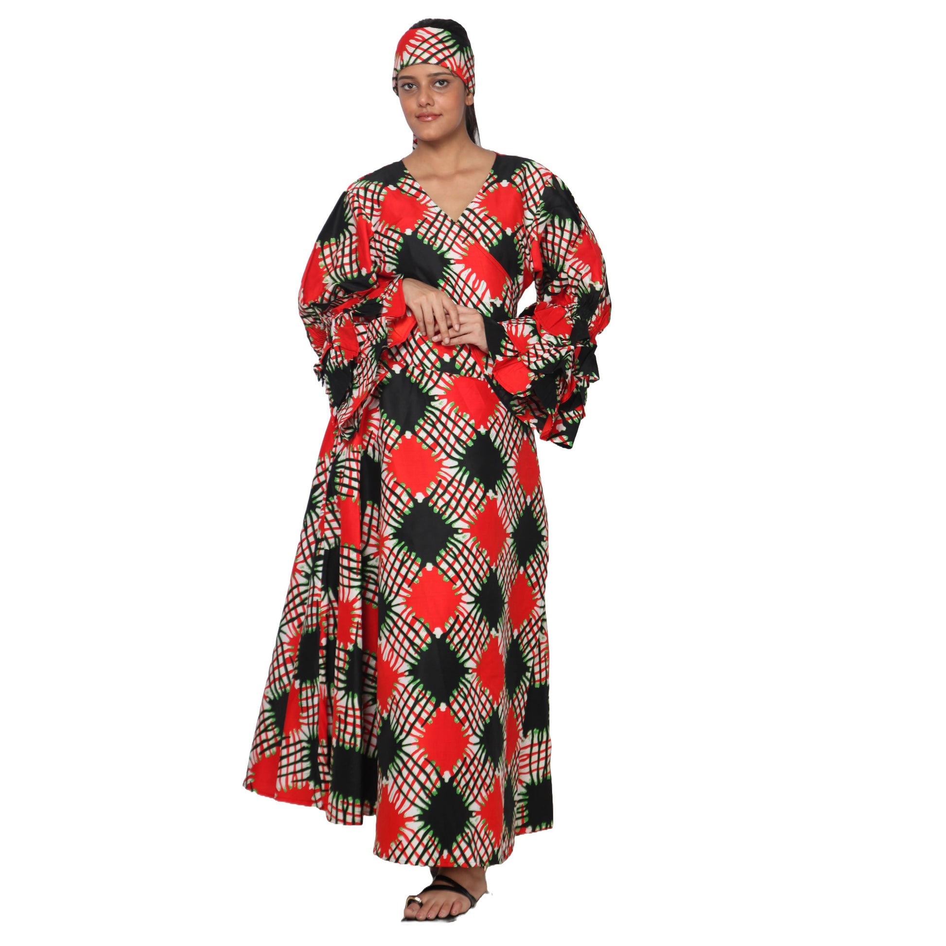 Woman wearing a colorful patterned dress and headscarf on a white background